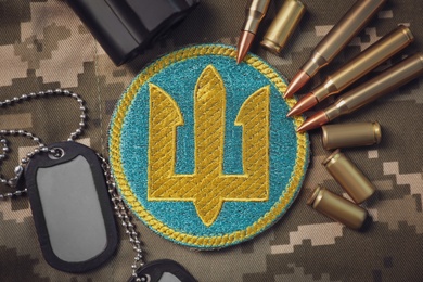 MYKOLAIV, UKRAINE - SEPTEMBER 19, 2020: Flat lay composition with Ukraine military equipment on camouflage background