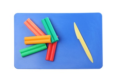 Many different colorful plasticine pieces and sculpting knife on white background, top view