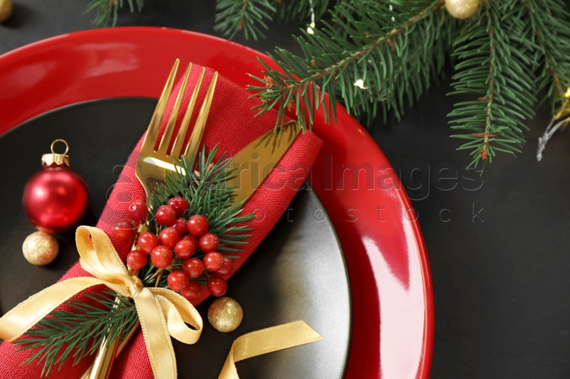 Photo of Beautiful Christmas table setting on black background, above view