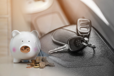 Buying vehicle. Double exposure of car key and piggy bank with coins