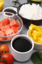 Photo of Ingredients for poke bowl on grey table