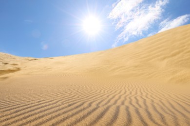Picturesque view of sandy desert and blue sky on hot sunny day 