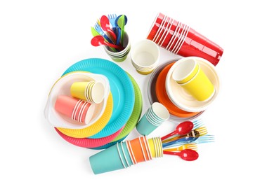 Set with different disposable tableware on white background, top view