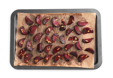 Baking tray with roasted beetroot slices on white background, top view