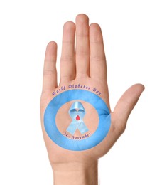 Man showing blue circle, awareness ribbon with paper blood drop as World Diabetes Day symbol on palm against white background, closeup of hand