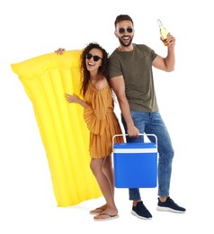 Happy couple with cool box, inflatable mattress and bottle of beer on white background