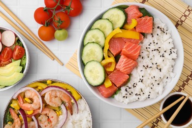 Photo of Set of delicious poke bowls with different ingredients on white table, flat lay