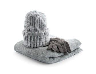 Woolen gloves, scarf and hat on white background