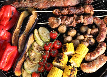 Tasty meat and vegetables on barbecue grill outdoors, top view