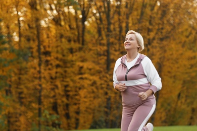 Mature woman jogging in park. Active lifestyle