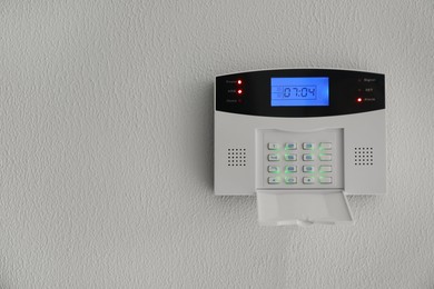 Photo of Home security system on white wall indoors, space for text