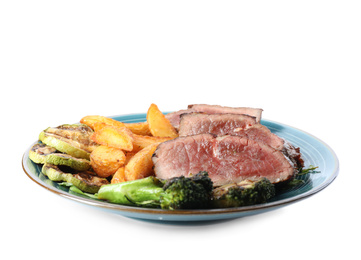 Delicious beef steak served with vegetables and fried potatoes isolated on white