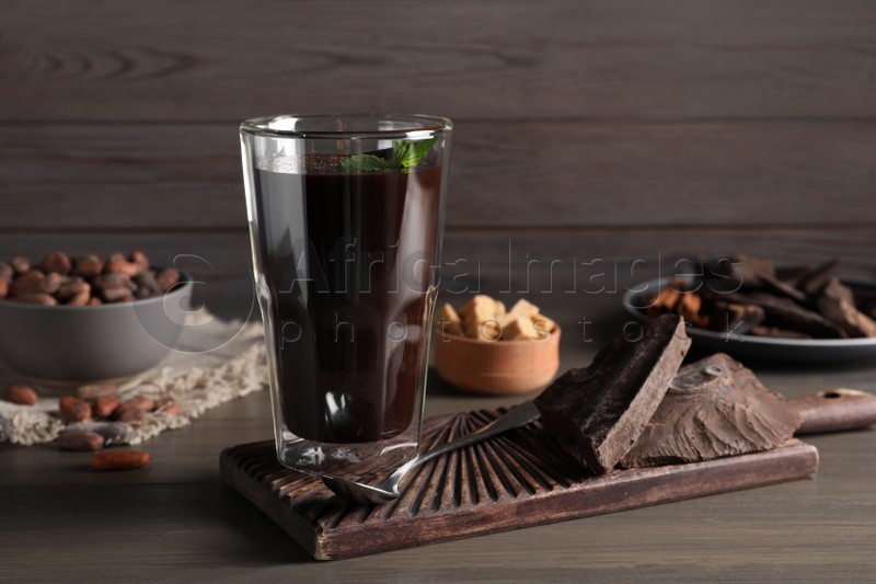 Glass of delicious hot chocolate on wooden table