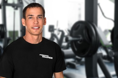 Image of Portrait of professional personal trainer in gym. Space for text