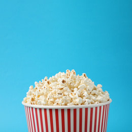 Delicious popcorn on light blue background, closeup