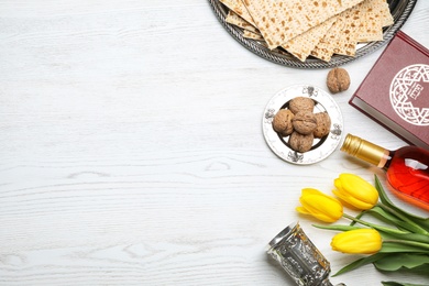 Flat lay composition with symbolic Passover (Pesach) items on wooden background, space for text