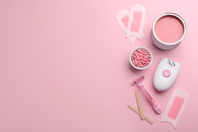Set of epilation tools and products on pink background, flat lay. Space for text