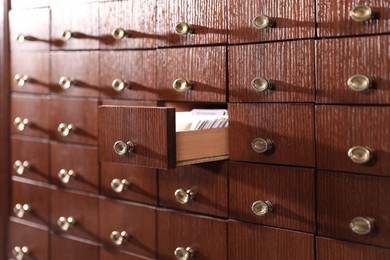 Open wooden drawer with index cards of library catalog