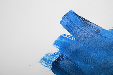 Paint strokes on white background background, top view. Color of the year 2020 (Classic blue)