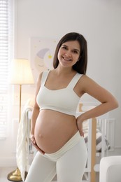 Happy pregnant woman at home. Choosing baby name