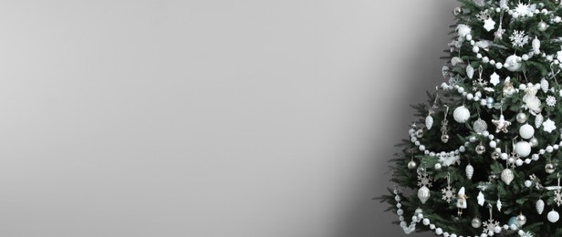 Beautifully decorated Christmas tree on white background, space for text. Banner design