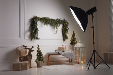 Beautiful Christmas themed photo zone with professional equipment and fir decor