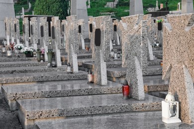 Many granite tombstones on cemetery. Funeral ceremony