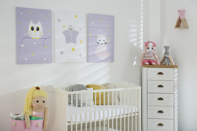 Baby room interior with cute posters and crib