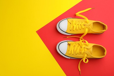 Pair of trendy sneakers on color background, flat lay. Space for text