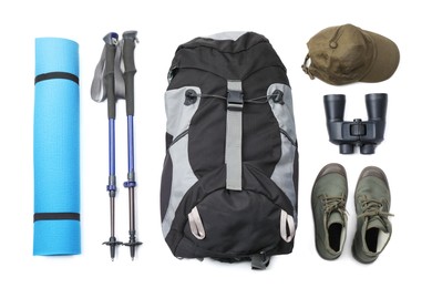 Photo of Pair of trekking poles and camping equipment for tourism on white background, top view