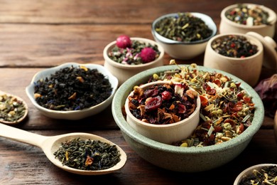 Many different herbal teas on wooden table