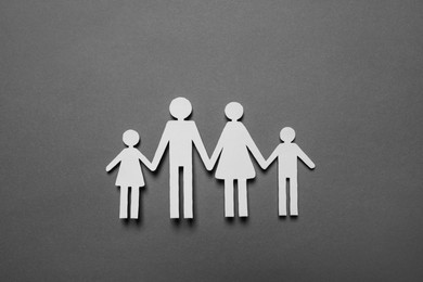 Paper family figures on grey background, top view. Insurance concept