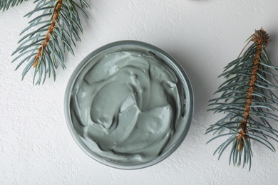 Professional face mask with spruce on white table, flat lay
