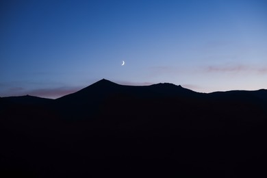 Silhouette of mountains against beautiful sky at night