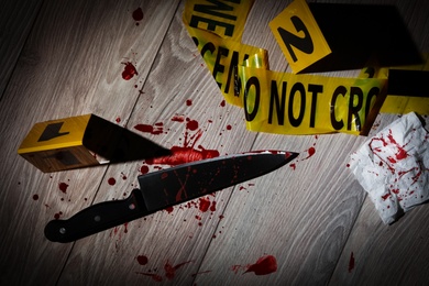 Photo of Flat lay composition with evidences and crime scene markers on wooden background