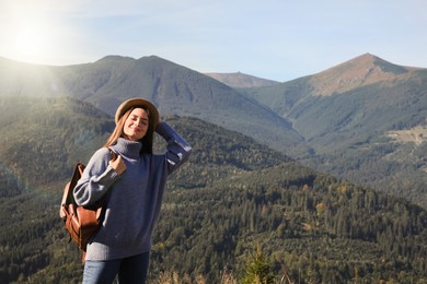 Young woman in beautiful mountains on sunny day
