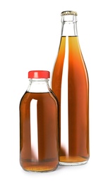 Photo of Glass bottles of delicious kvass on white background. Refreshing drink