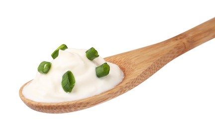Delicious sour cream with chives in wooden spoon on white background