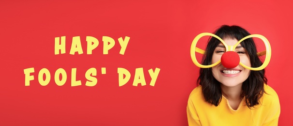 Funny woman with large glasses and clown nose on red background, banner design. Happy fool's day