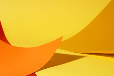 Photo of Different colorful paper sheets on yellow background