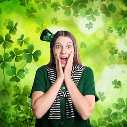 Emotional woman in St. Patrick's Day outfit on green background