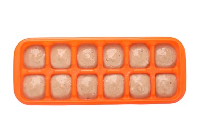 Banana puree in ice cube tray isolated on white, top view