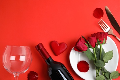 Romantic table setting on red background, flat lay with space for text. Valentine's day celebration