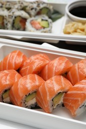 Delicious sushi rolls in plastic containers, closeup. Food delivery