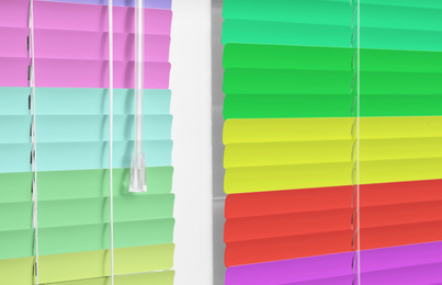 Image of Closed multicolor window blinds as background, closeup view
