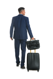 Businessman with suitcase and bag for vacation trip on white background, back view. Summer travelling