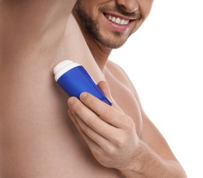 Man applying deodorant isolated on white, closeup