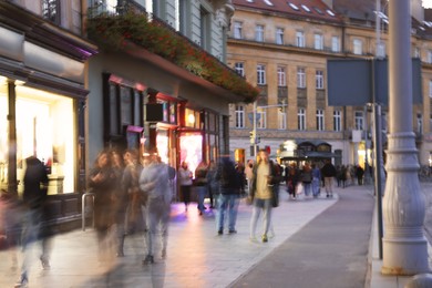 People walking on city street, long exposure effect