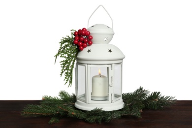 Christmas lantern decorated with coniferous twigs and berries on grey background