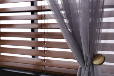 Window with beautiful curtain and blinds, closeup
